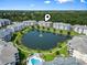 Overhead shot of condo complex with lake, palm trees, outdoor pool and manicured landscaping at 4851 Luster Leaf Circle # 302, Myrtle Beach, SC 29577