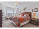 Bedroom featuring bed with colorful quilt, side tables, and a chair near the windows at 4851 Luster Leaf Circle # 302, Myrtle Beach, SC 29577