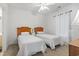 Bright bedroom featuring two twin beds with wooden headboards and a ceiling fan at 4851 Luster Leaf Circle # 302, Myrtle Beach, SC 29577