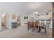 Dining area with seating for six adjacent to kitchen and featuring stylish decor, lighting, and carpet floors at 4851 Luster Leaf Circle # 302, Myrtle Beach, SC 29577