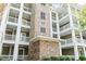 Exterior of condo building showcasing stacked balconies and brick facade with unit number at 4851 Luster Leaf Circle # 302, Myrtle Beach, SC 29577