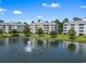 Scenic view of the condo buildings overlooking the lake with a fountain and trees at 4851 Luster Leaf Circle # 302, Myrtle Beach, SC 29577