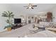 Bright living room featuring neutral carpet, modern decor, ceiling fan, and open access to the dining area and kitchen at 4851 Luster Leaf Circle # 302, Myrtle Beach, SC 29577