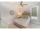 This bedroom has a decorative ceiling fan, queen bed, and unique sand dollar and swimmer wall art at 4904 Salt Creek Ct., North Myrtle Beach, SC 29582