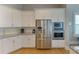 Bright, modern kitchen featuring stainless steel appliances, white cabinetry, and granite countertops at 4904 Salt Creek Ct., North Myrtle Beach, SC 29582