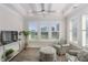 Sun room includes plantation shutters, a ceiling fan, and comfortable seating at 4904 Salt Creek Ct., North Myrtle Beach, SC 29582