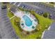 Aerial view of community pool with blue water, lounge chairs, and shade umbrellas at 4933 Crab Pond Ct. # 202, Myrtle Beach, SC 29579