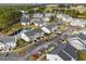 Aerial view of condominiums with mature trees and manicured grounds near a golf course at 4933 Crab Pond Ct. # 202, Myrtle Beach, SC 29579