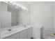 Bright bathroom with double sinks and large mirror at 4933 Crab Pond Ct. # 202, Myrtle Beach, SC 29579