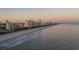 Panoramic coastal view showcases the beach at sunset, with the city's hotel skyline visible at 4933 Crab Pond Ct. # 202, Myrtle Beach, SC 29579