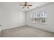 Comfortable bedroom featuring a ceiling fan and large window providing ample natural light for a cozy atmosphere at 4933 Crab Pond Ct. # 202, Myrtle Beach, SC 29579