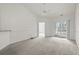 Bright living room with neutral carpet, ceiling fan, and a sliding door leading to a patio at 4933 Crab Pond Ct. # 202, Myrtle Beach, SC 29579