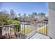 Balcony view of the parking lot and wooded area at 5001 Little River Rd. # W-214, Myrtle Beach, SC 29577