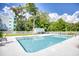 Community pool with a white fence and lots of trees at 5001 Little River Rd. # W-214, Myrtle Beach, SC 29577