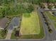 Aerial view of a property highlighting a large vacant lot, surrounded by greenery and residential homes at 600 Barona Dr., Myrtle Beach, SC 29579