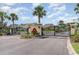 Gated community entrance with black iron gates, landscaped pillars, and a central fountain feature, all under a blue sky at 600 Barona Dr., Myrtle Beach, SC 29579