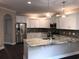 Modern kitchen featuring white cabinetry, stainless steel appliances, granite countertops, and stylish pendant lighting at 600 Barona Dr., Myrtle Beach, SC 29579