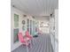 Inviting front porch with pink chairs and a gray floor at 6001-6012 S Kings Hwy., Myrtle Beach, SC 29575