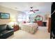 Bright bedroom featuring a cozy bed, ceiling fan, and natural light from a window at 604 Six Lakes Dr., Myrtle Beach, SC 29588