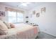 Bright bedroom with a patterned bedspread, complemented by natural light streaming through the window at 604 Six Lakes Dr., Myrtle Beach, SC 29588