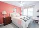 Charming bedroom with a coral accent wall, adorned with a comfortable bed and coordinated decor at 604 Six Lakes Dr., Myrtle Beach, SC 29588