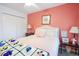 Comfortable bedroom featuring a tufted headboard, bedside table, and a soothing coral wall at 604 Six Lakes Dr., Myrtle Beach, SC 29588