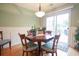 Light-filled dining area with wood flooring and a view of the backyard through sliding glass doors at 604 Six Lakes Dr., Myrtle Beach, SC 29588