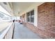 Charming front porch with rocking chairs, swing and brick exterior creating a welcoming entrance at 604 Six Lakes Dr., Myrtle Beach, SC 29588