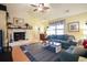 Open living room featuring a white-painted brick fireplace and hardwood floors at 604 Six Lakes Dr., Myrtle Beach, SC 29588