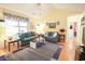 Bright living room featuring hardwood floors, vaulted ceiling, and comfortable blue sofas at 604 Six Lakes Dr., Myrtle Beach, SC 29588