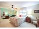 Spacious main bedroom featuring neutral décor, a ceiling fan, and a bright window at 604 Six Lakes Dr., Myrtle Beach, SC 29588