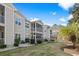 View of the back of the condo showing screened porches and a well maintained lawn at 6208 Sweetwater Blvd. # 6208, Murrells Inlet, SC 29576