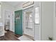 Bright foyer features decorative rug, coat closet and a storm door with natural light and rich flooring at 6208 Sweetwater Blvd. # 6208, Murrells Inlet, SC 29576