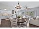 Relaxing living space featuring a balcony, ceiling fan and a dining area with a modern chandelier at 6208 Sweetwater Blvd. # 6208, Murrells Inlet, SC 29576