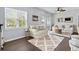 Bright living room featuring large windows, comfortable seating, and a stylish area rug at 6208 Sweetwater Blvd. # 6208, Murrells Inlet, SC 29576