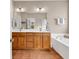 Double vanity bathroom with soaking tub and tiled floors at 644 Serendipity Circle, Murrells Inlet, SC 29576