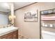 A bathroom with a white granite countertop vanity, a white toilet, and a shower with a floral curtain at 6461 Norton Rd., Green Sea, SC 29545