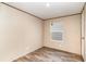 Neutral bedroom with wood flooring and a window providing natural light at 6461 Norton Rd., Green Sea, SC 29545