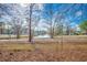 Scenic backyard view overlooking a pond, featuring mature trees and surrounding homes in a serene setting at 6644 E Sweetbriar Trail, Myrtle Beach, SC 29588