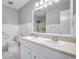 Bathroom featuring dual sinks, wainscoting, and modern fixtures at 6644 E Sweetbriar Trail, Myrtle Beach, SC 29588