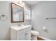 Bathroom features a large mirror, white vanity, and tile flooring at 6644 E Sweetbriar Trail, Myrtle Beach, SC 29588