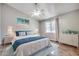 Cozy bedroom with a ceiling fan, beach themed art, hardwood floors, and bright natural light at 6644 E Sweetbriar Trail, Myrtle Beach, SC 29588