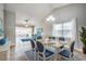 Bright dining area featuring vaulted ceilings, a white table, and blue chairs with open access to living area at 6644 E Sweetbriar Trail, Myrtle Beach, SC 29588