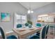 Bright dining room with high ceilings, a modern chandelier, and seating for six with a view to the kitchen at 6644 E Sweetbriar Trail, Myrtle Beach, SC 29588