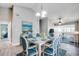 Bright dining area featuring vaulted ceilings, a white table, and blue chairs with open access to living area at 6644 E Sweetbriar Trail, Myrtle Beach, SC 29588