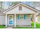 Charming single-story home features blue shutters, a covered porch, and a welcoming entrance at 6644 E Sweetbriar Trail, Myrtle Beach, SC 29588