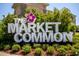 The Market Common signage is surrounded by mature landscaping and a vibrant atmosphere at 6644 E Sweetbriar Trail, Myrtle Beach, SC 29588