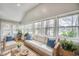 Cozy sunroom filled with natural light, comfortable wicker seating, and views of the surrounding trees at 6644 E Sweetbriar Trail, Myrtle Beach, SC 29588