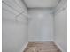 Simple walk-in closet space with wire shelving and wood-look laminate flooring at 6644 E Sweetbriar Trail, Myrtle Beach, SC 29588