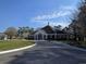 Brick clubhouse with a shingled roof and landscaping at 703 Riverwalk Dr. # 103, Myrtle Beach, SC 29579